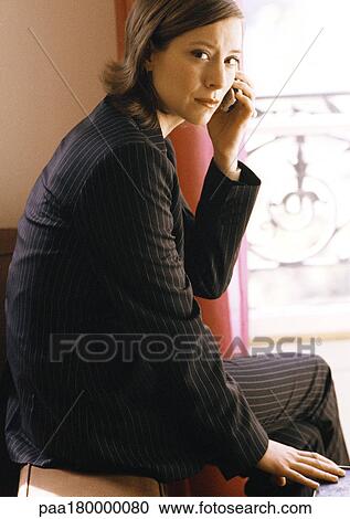 Stock Image - Woman using cell phone, portrait. Fotosearch