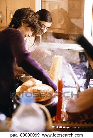 Women preparing pasta in kitchen View Large Photo Image Stock Photo - Women preparing pasta in kitchen. Fotosearch
