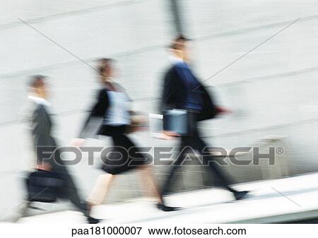 Business people walking in street, full length, tilt, blurred View Large Photo Image Stock Photo - Business people walking in street, full length, tilt, blurred. Fotosearch