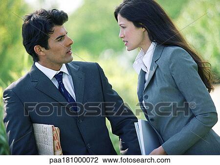 Businessman and woman talking outdoors View Large Photo Image Stock Image - Businessman and woman talking outdoors. Fotosearch