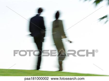 Businessman and woman walking on grass, rear view, blurred View Large Photo Image Stock Image - Businessman and woman walking on grass, rear view, blurred. Fotosearch