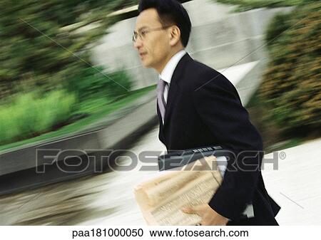 Businessman hurrying, outdoors, blurred View Large Photo Image Stock Image - Businessman hurrying, outdoors, blurred. Fotosearch
