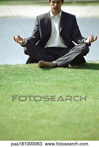 Businessman in lotus position on grass View Large Photo Image Stock Image - Businessman in lotus position on grass. Fotosearch