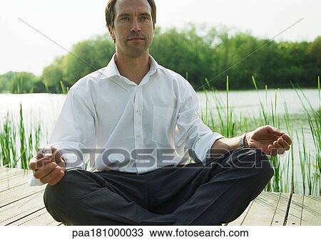 Businessman in lotus position, outdoors View Large Photo Image Stock Image - Businessman in lotus position, outdoors. Fotosearch