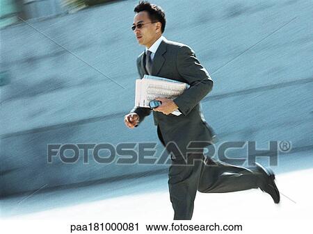 Businessman running outdoors View Large Photo Image Stock Image - Businessman running outdoors. Fotosearch