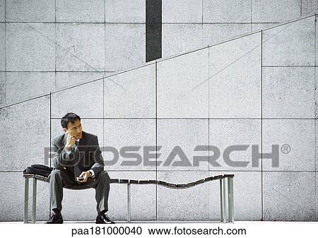 Businessman sitting on bench View Large Photo Image Stock Image - Businessman sitting on bench. Fotosearch