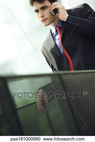 Stock Image - Businessman using cell phone, close-up. Fotosearch