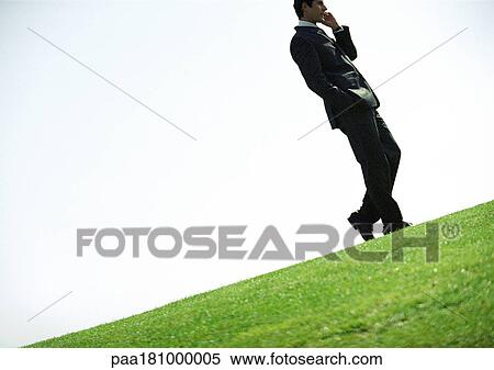 Businessman using cell phone outdoors, tilt View Large Photo Image Stock Photography - Businessman using cell phone outdoors, tilt. Fotosearch