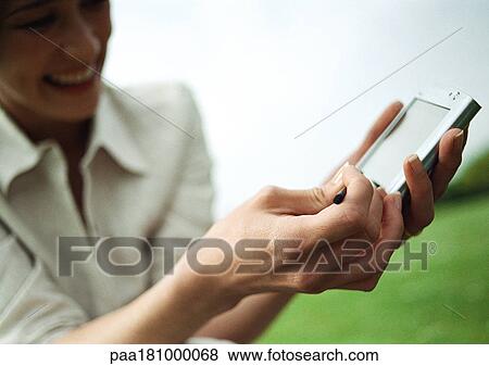 Woman showing electronic organizer, close-up of hands View Large Photo Image Stock Photo - Woman showing electronic organizer, close-up of hands. Fotosearch
