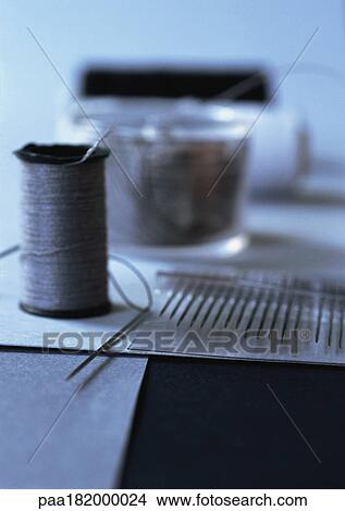 Thread and sewing needles, close-up View Large Photo Image Picture - Thread and sewing needles, close-up. Fotosearch