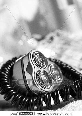 Stock Image - Electric razor, close-up, b&w. Fotosearch