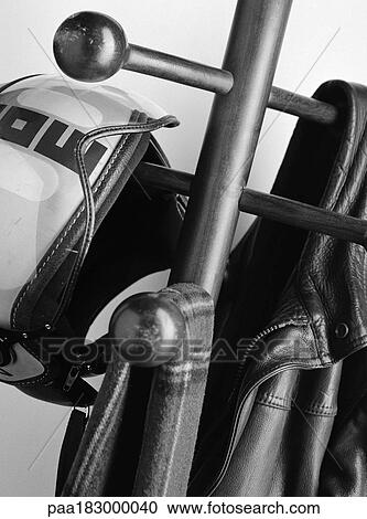 Jacket, helmet and scarf on coat rack, close-up, b&w View Large Photo Image Stock Image - Jacket, helmet and scarf on coat rack, close-up, b&w. Fotosearch