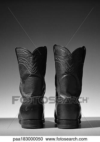 Stock Image - Leather cowboy boots, close-up, b&w. Fotosearch