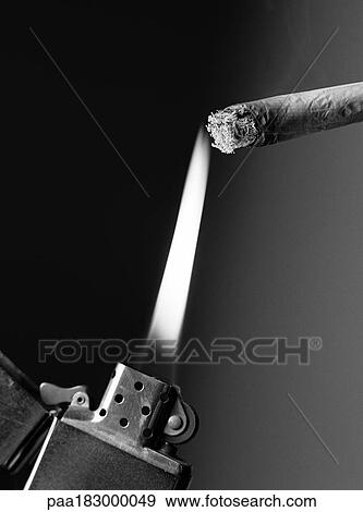 Stock Photo - Lighter and cigarette, close-up, b&w. Fotosearch