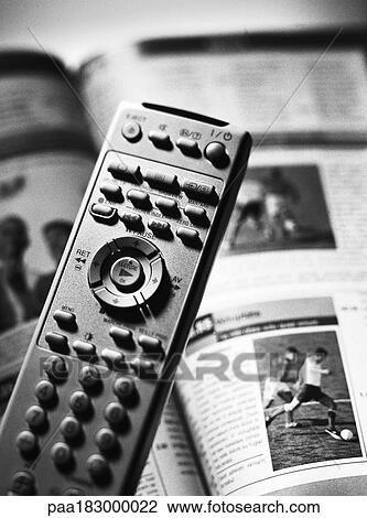 Remote control and tv program, close-up, b&w View Large Photo Image Stock Image - Remote control and tv program, close-up, b&w. Fotosearch