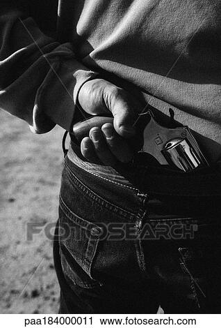 Hand taking gun from back of pants, close-up, b&w View Large Photo Image Stock Image - Hand taking gun from back of pants, close-up, b&w. Fotosearch