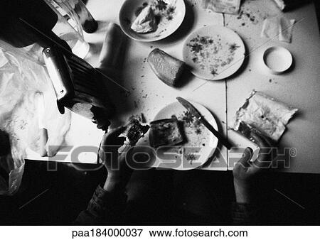 Hands holding food on dirty table, b&w View Large Photo Image Stock Photo - Hands holding food on dirty table, b&w. Fotosearch