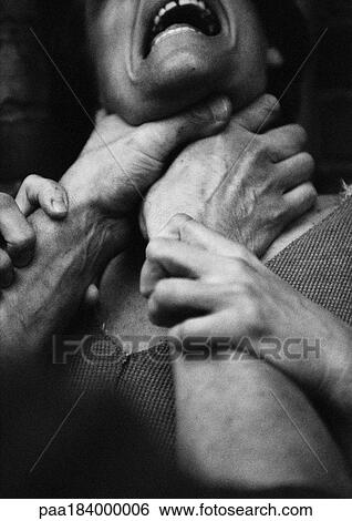 Stock Photograph - Hands strangling woman, close-up, b&w. Fotosearch