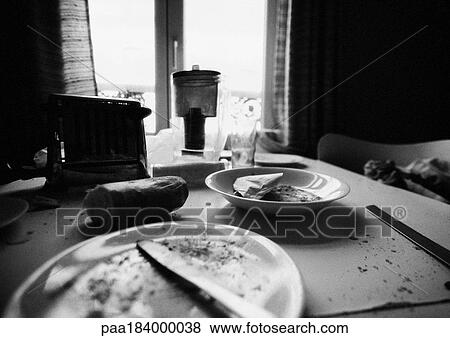 Stock Photo - Leftovers on dirty table, b&w. Fotosearch