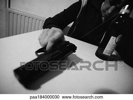 Man holding gun, close-up of hand holding gun on table, close-up, b&w View Large Photo Image Stock Image - Man holding gun, close-up of hand holding gun on table, close-up, b&w. Fotosearch