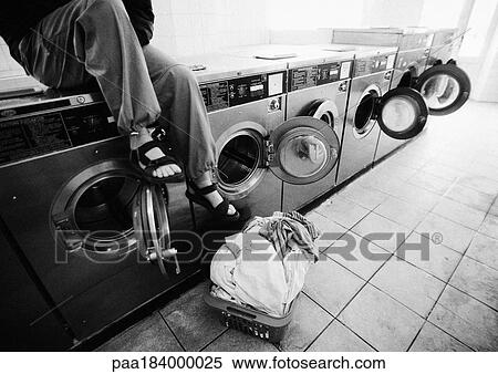 Person sitting on washing machine in laundrymat, low section, b&w View Large Photo Image Stock Photography - Person sitting on washing machine in laundrymat, low section, b&w. Fotosearch