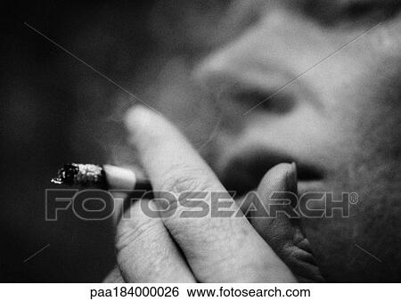 Person smoking cigarette, close-up, blurred, b&w View Large Photo Image Stock Photograph - Person smoking cigarette, close-up, blurred, b&w. Fotosearch