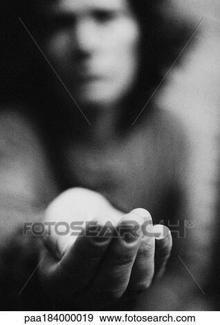 Woman holding hand out, blurred, b&w View Large Photo Image Stock Photo - Woman holding hand out, blurred, b&w. Fotosearch