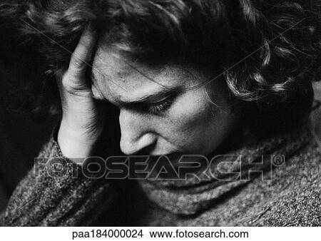 Woman holding head, close-up, b&w View Large Photo Image Picture - Woman holding head, close-up, b&w. Fotosearch
