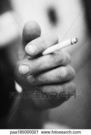 Hand holding cigarette, close-up, b&w View Large Photo Image Stock Image - Hand holding cigarette, close-up, b&w. Fotosearch