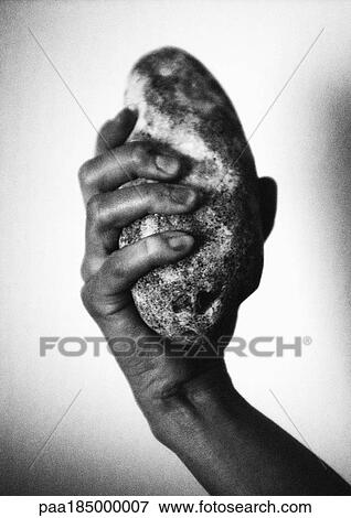 Hand holding stone, close-up, b&w View Large Photo Image Stock Photo - Hand holding stone, close-up, b&w. Fotosearch
