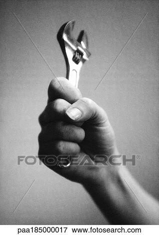 Hand holding wrench, close-up, b&w View Large Photo Image Stock Photo - Hand holding wrench, close-up, b&w. Fotosearch
