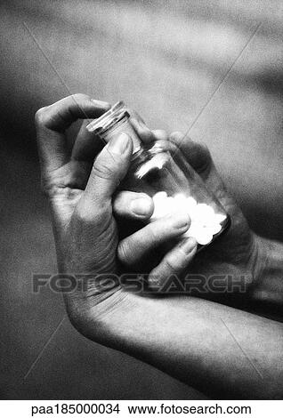 Hands holding bottle of pills, close-up, b&w View Large Photo Image Picture - Hands holding bottle of pills, close-up, b&w. Fotosearch