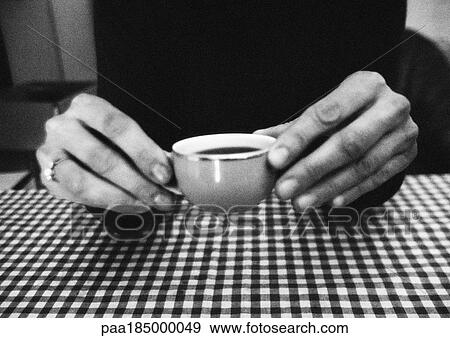 Stock Photo - Hands holding cup, close-up, b&w. Fotosearch