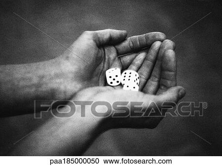 Stock Image - Hands holding dice, close-up, b&w. Fotosearch