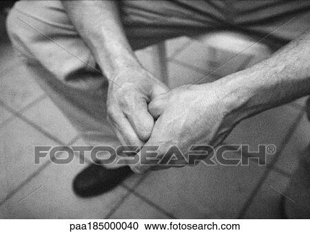 Stock Image - Man's clasped hands, close-up, b&w. Fotosearch