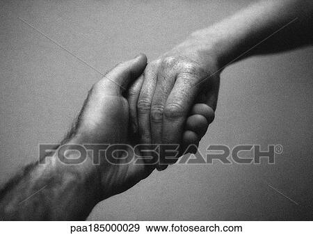 Stock Photo - People holding hands, close-up, b&w. Fotosearch