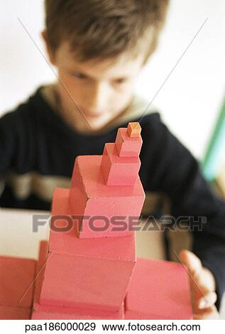 Child behind stack of blocks, focus on foreground View Large Photo Image Stock Photo - Child behind stack of blocks, focus on foreground. Fotosearch