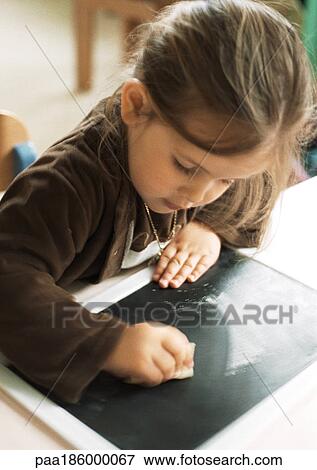 Child cleaning chalkboard View Large Photo Image Stock Photo - Child cleaning chalkboard. Fotosearch