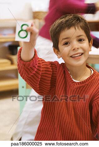 Child holding card, smiling View Large Photo Image Stock Photography - Child holding card, smiling. Fotosearch