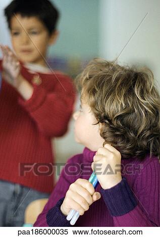 Child holding pens looking at second child, side view View Large Photo Image Stock Photography - Child holding pens looking at second child, side view. Fotosearch