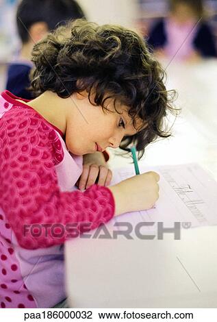 Child in classroom, writing, side view View Large Photo Image Stock Image - Child in classroom, writing, side view. Fotosearch