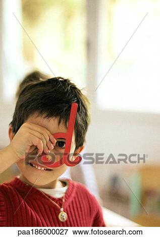 Child looking through plastic letter, portrait View Large Photo Image Stock Photo - Child looking through plastic letter, portrait. Fotosearch