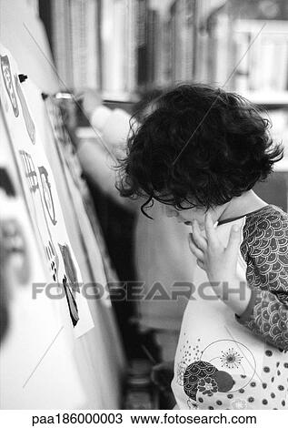 Stock Image - Child painting, side view, b&w. Fotosearch