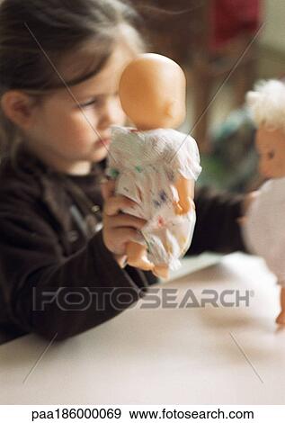 Child playing with baby dolls View Large Photo Image Stock Photo - Child playing with baby dolls. Fotosearch