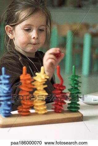 Child playing with colored pieces of plastics View Large Photo Image Stock Image - Child playing with colored pieces of plastics. Fotosearch