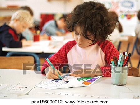 Child sitting at table, drawing, head and shoulders View Large Photo Image Stock Image - Child sitting at table, drawing, head and shoulders. Fotosearch