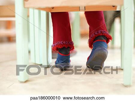Child sitting in classroom, low section View Large Photo Image Stock Image - Child sitting in classroom, low section. Fotosearch