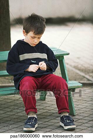 Child sitting on bench View Large Photo Image Stock Image - Child sitting on bench. Fotosearch