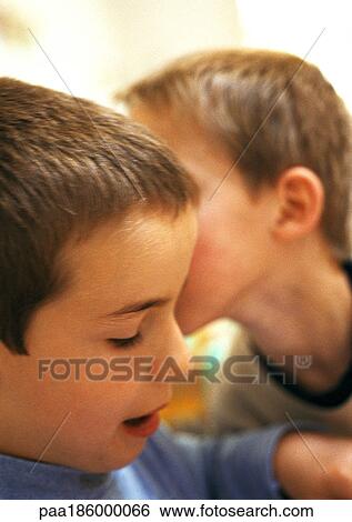 Child whispering to second child, close-up View Large Photo Image Stock Photograph - Child whispering to second child, close-up. Fotosearch