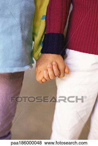 Children holding hands, close-up View Large Photo Image Stock Photo - Children holding hands, close-up. Fotosearch